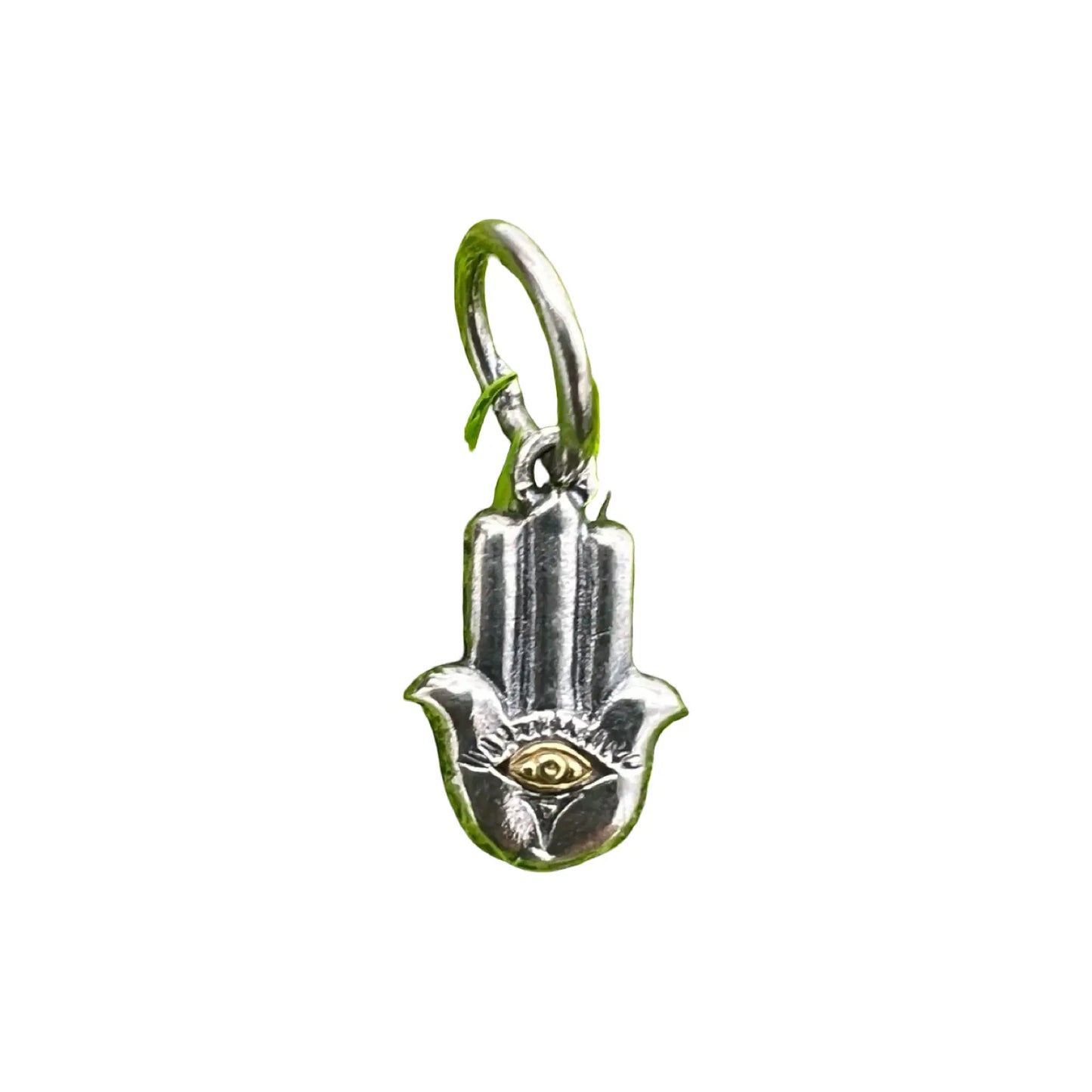 Silver Hamsa hand charm with eye design on a white background waxing poetic