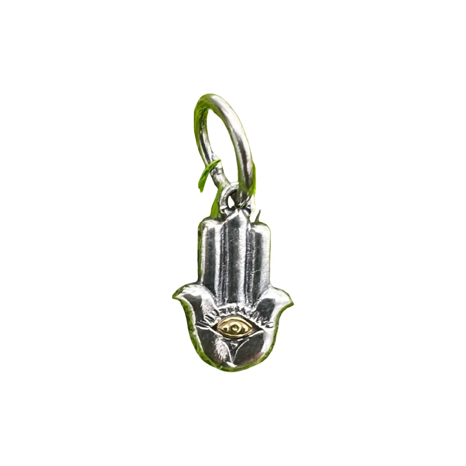 Silver Hamsa hand charm with eye design on a white background waxing poetic